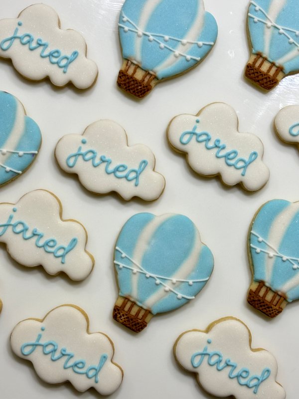 Hot-air balloon and cloud cookies in baby blue with hand-piped lettering