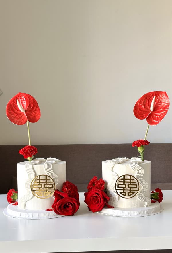Double-happiness celebration pair with red anthuriums