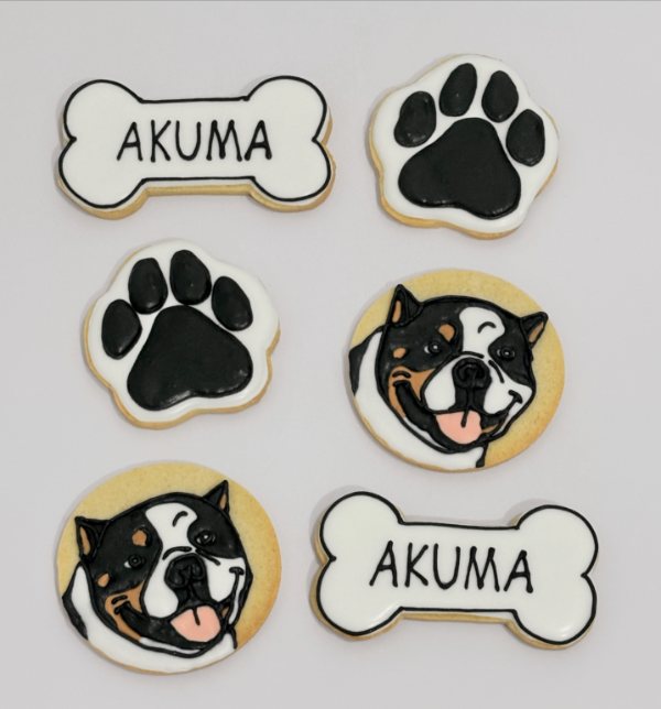 Pet celebration cookies — paw prints, bones and a hand-piped dog portrait