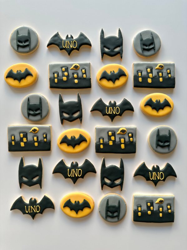 Caped-hero night cookies — masks, bat signals and a glowing city skyline