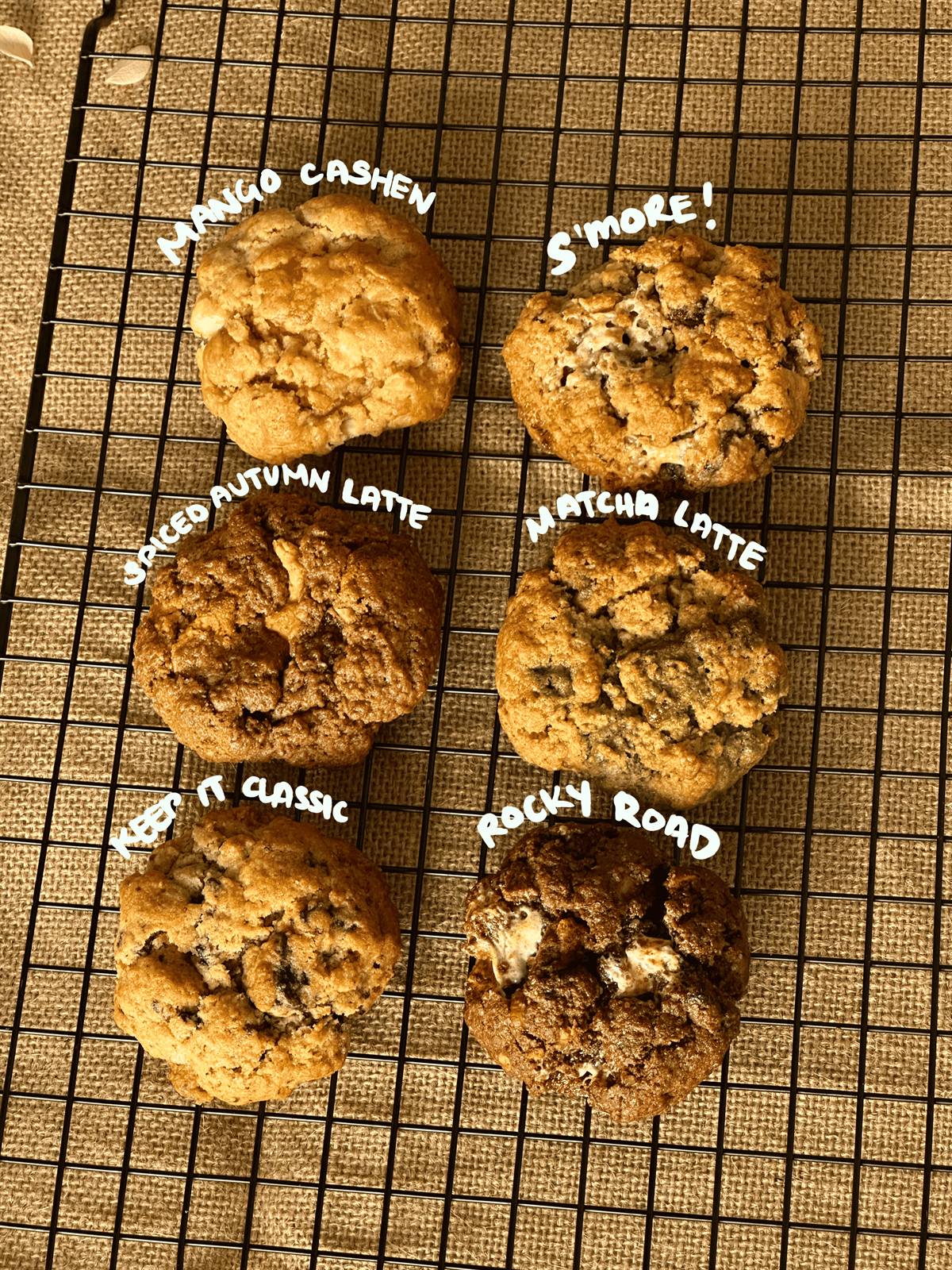 The complete Sugarcoat artisanal cookie collection — Mango Cashew, S'more, Spiced Autumn Latte, Matcha Latte, Keep it Classic, and Rocky Road — fresh from the rack