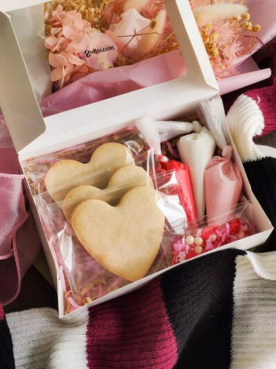 The Sugarcoat DIY Cookie Kit — heart cookies, piping bags of royal icing and sprinkles boxed with a guide
