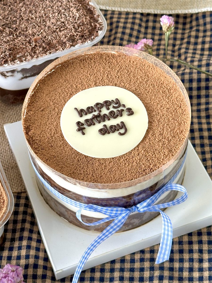 Tiramisu acetate cake, cocoa-dusted with a gingham bow