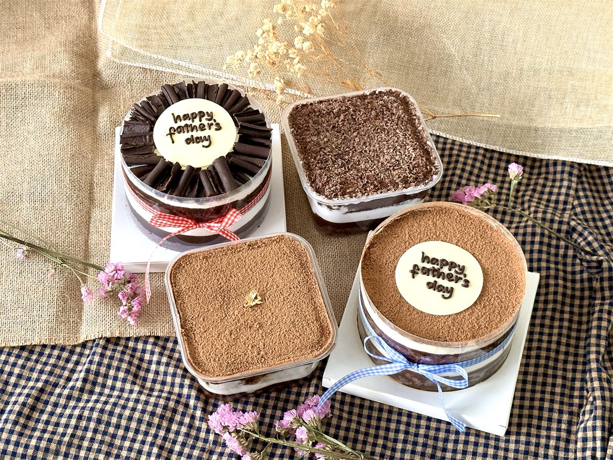 The Father's Day collection — Tiramisu and Black Forest cakes, dessert boxes, and hand-decorated cookies