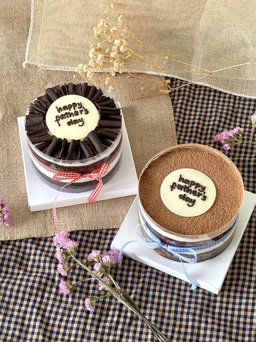 Tiramisu and Black Forest acetate cakes side by side