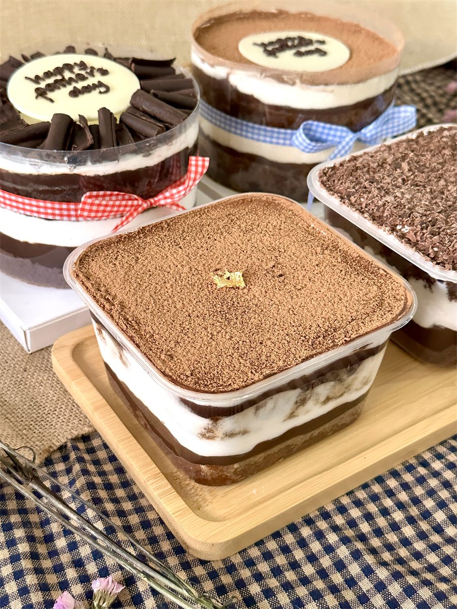 The cakes with a dessert box on a wooden board