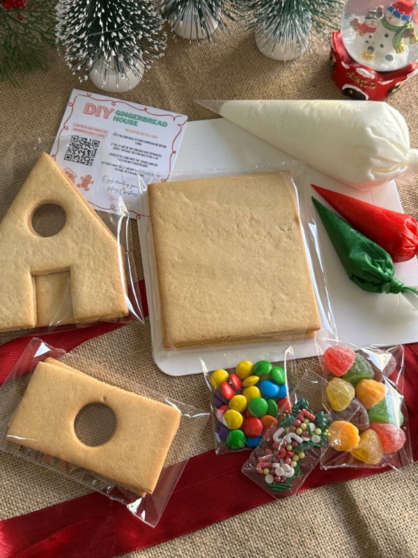 Everything inside the DIY kit &mdash; icing bags, house panels, candies, sprinkles and the instruction card
