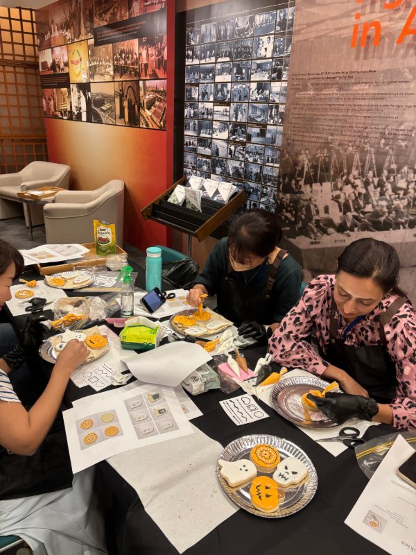 A team decorating Halloween cookies together at a corporate session