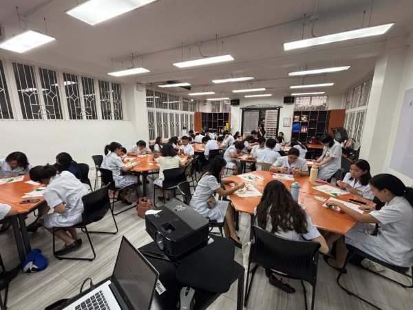 A university classroom mid-workshop, kits at every seat